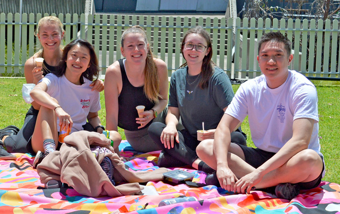 Students sitting on a picnic rug at O-week
